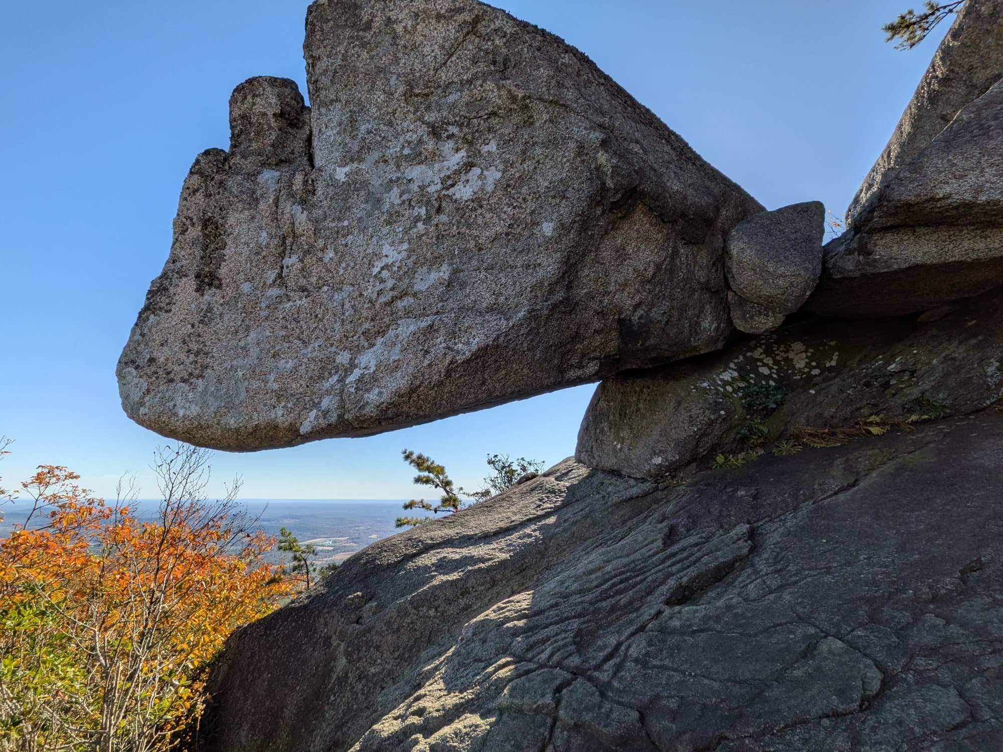 A multi-ton boulder balanced on a single narrow point of rock